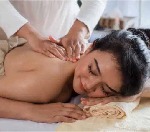 Woman enjoying a relaxing back massage at a professional spa in Ajman